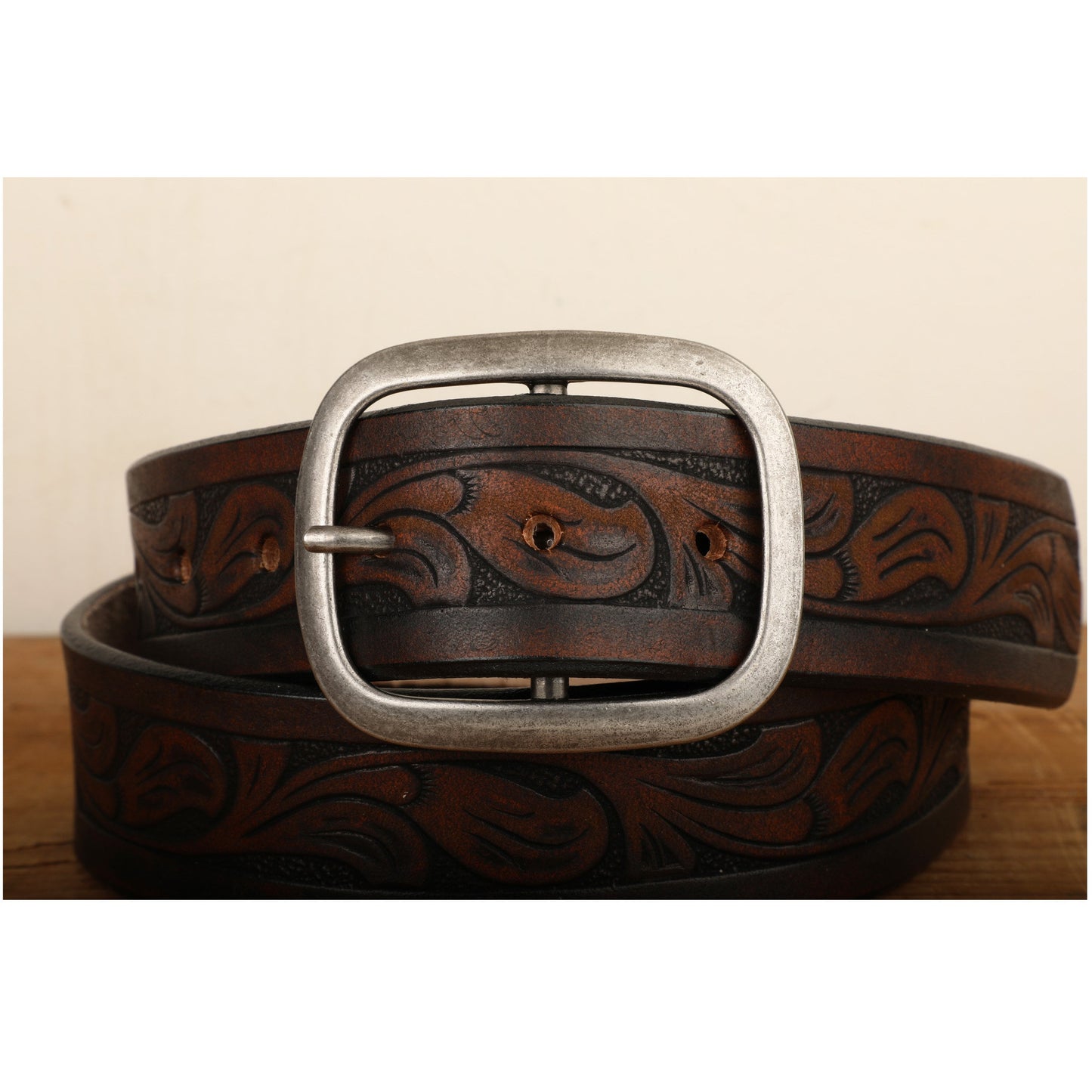 a brown belt with a metal buckle