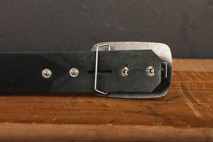 a black leather belt with a metal buckle