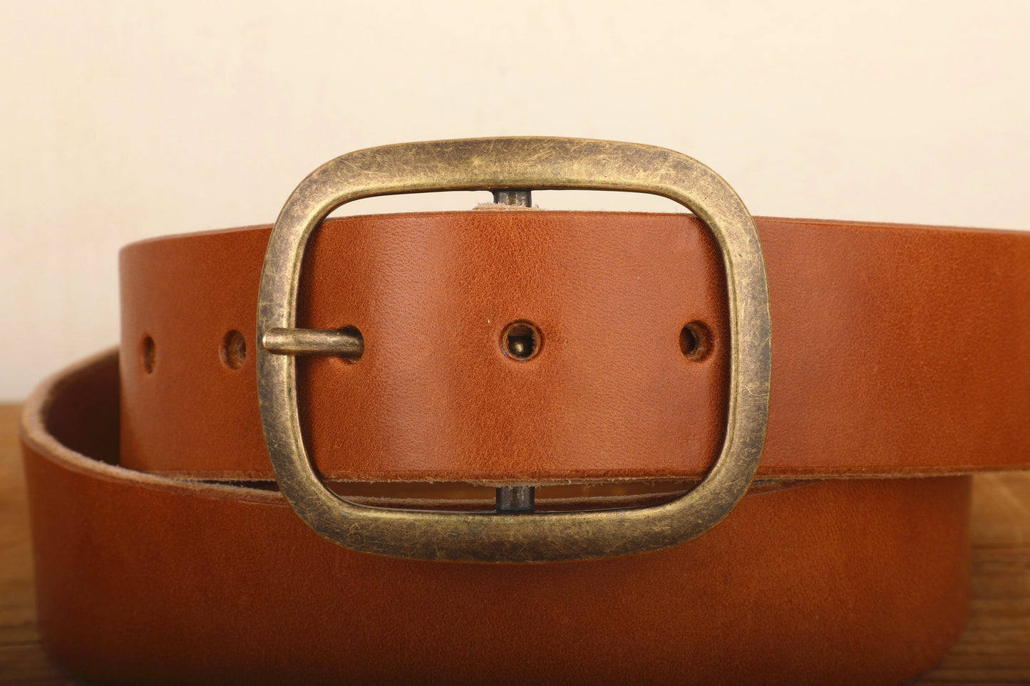 a brown leather belt with a metal buckle