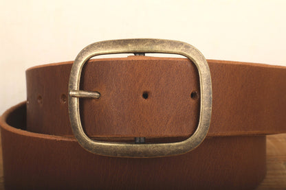 a close up of a belt on a wooden surface