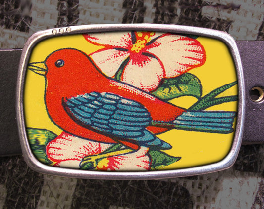 a red bird sitting on top of a flower covered belt