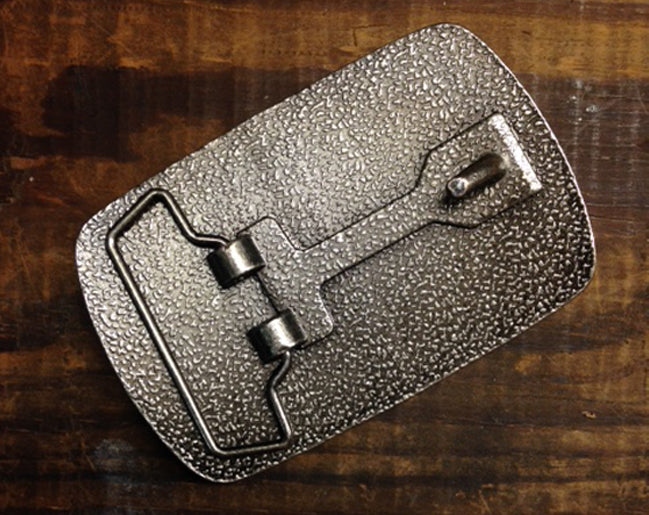 a silver purse sitting on top of a wooden table