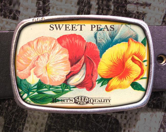 a belt buckle with flowers painted on it