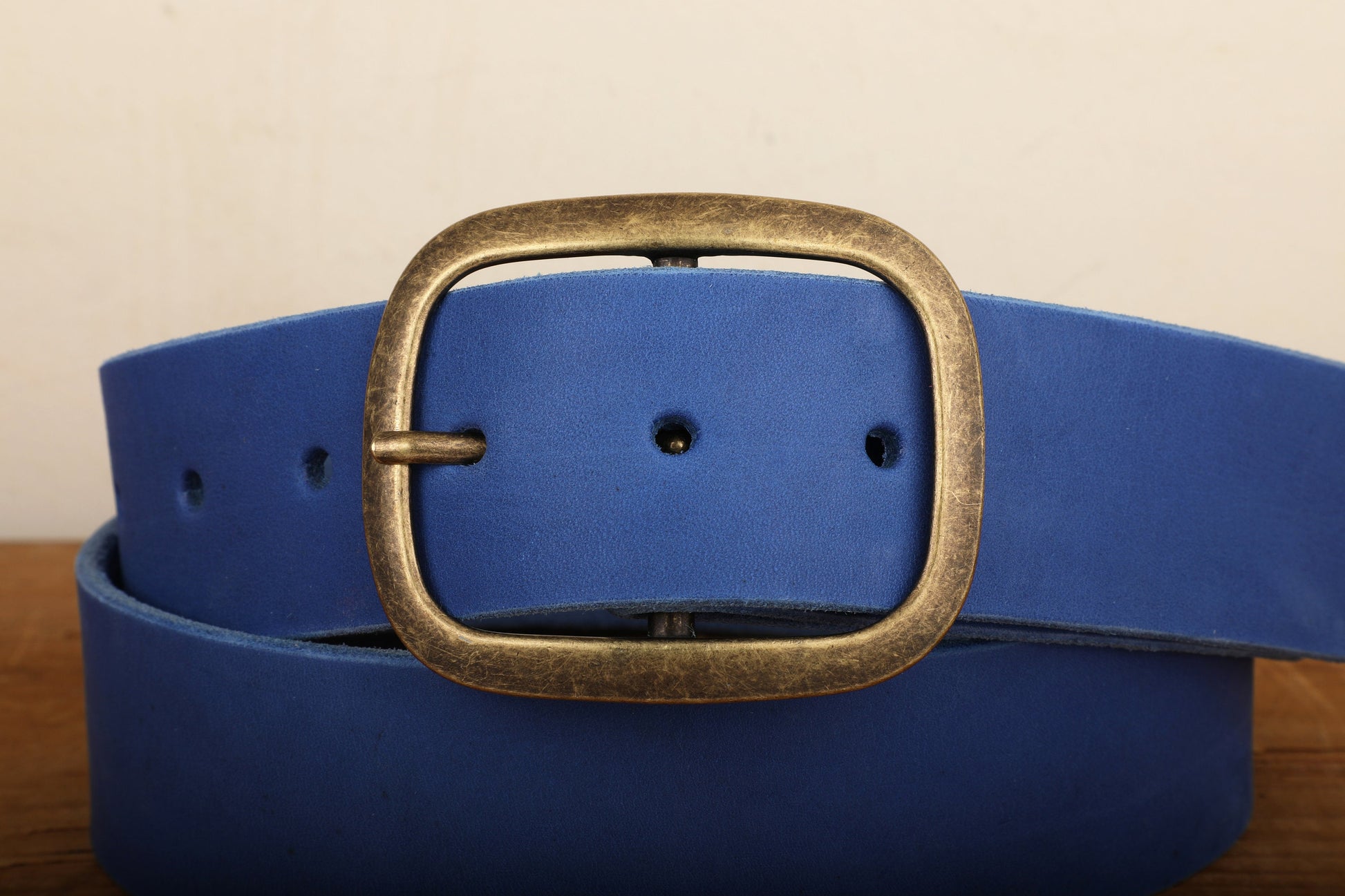 a close up of a blue belt on a wooden surface