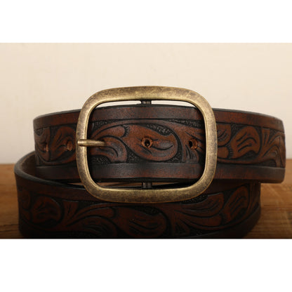 a brown belt with a metal buckle on a wooden table