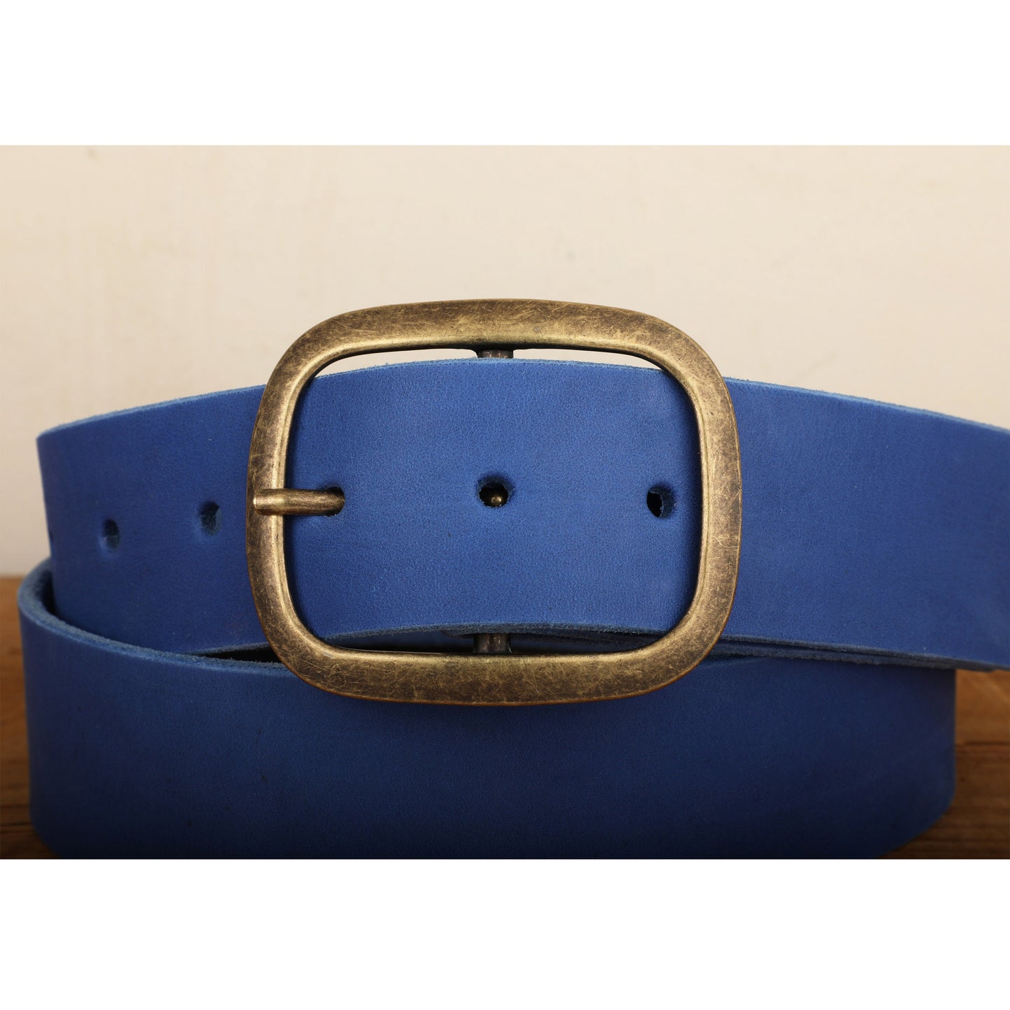 a blue belt with a gold buckle