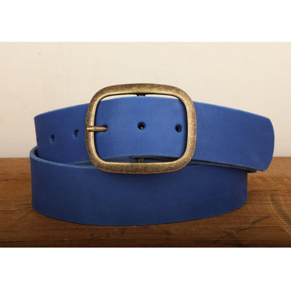 a blue belt with a gold buckle on a wooden table