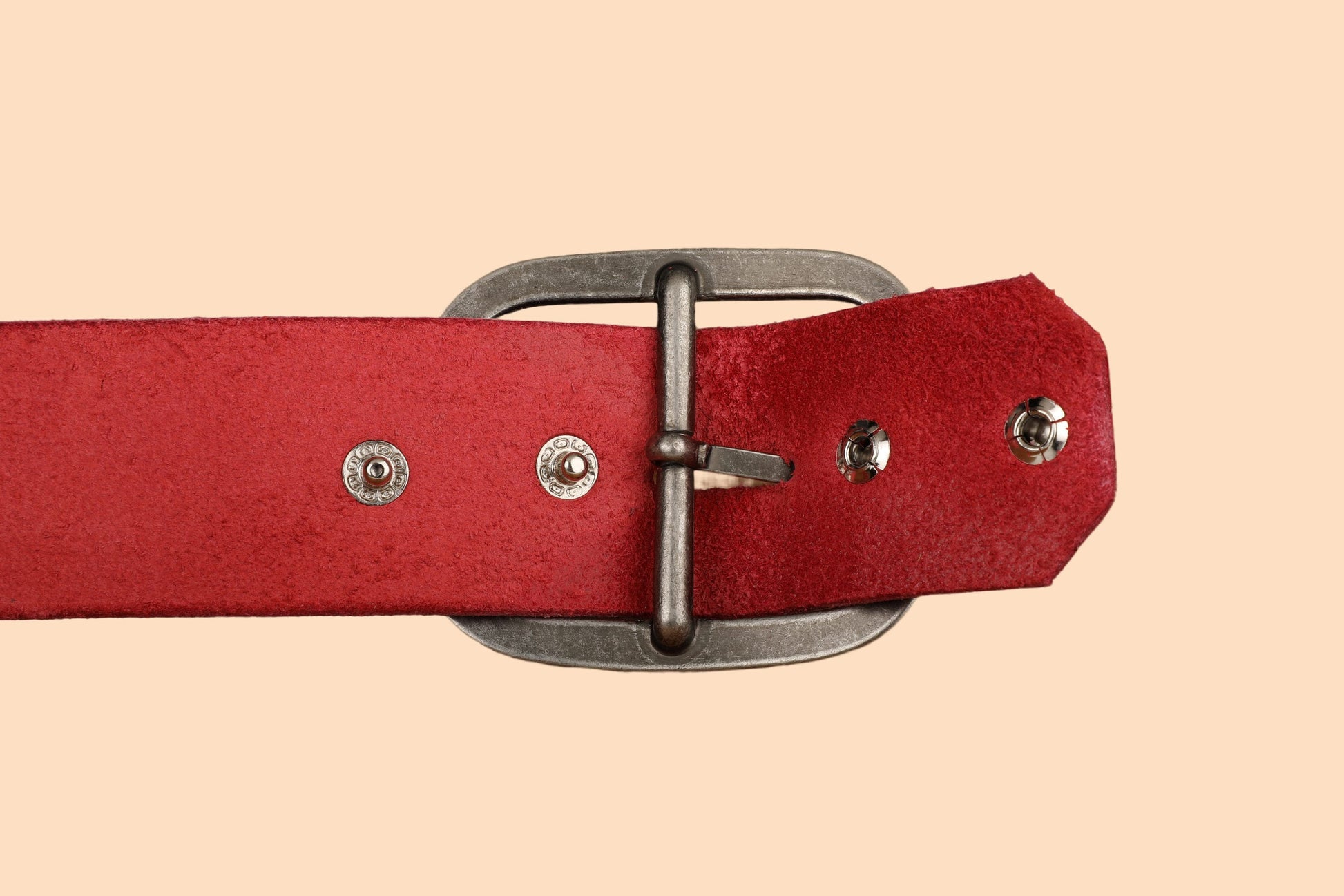 a close up of a red belt on a beige background
