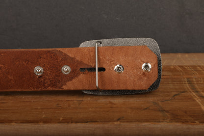 a brown leather belt with silver studs on it